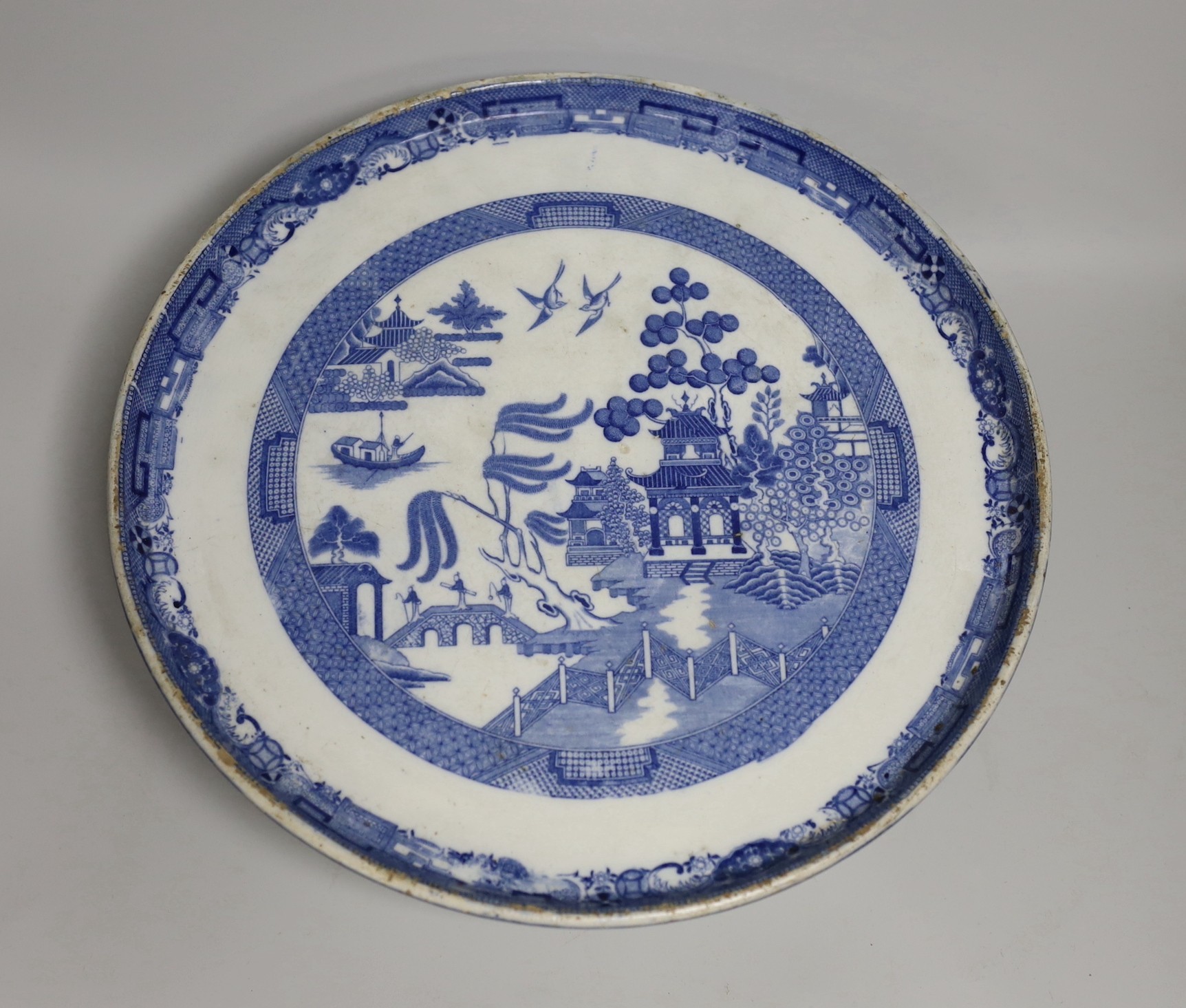 Blue and white pottery- A Victorian Willow pattern comport, a biscuit barrel and an urn with cover